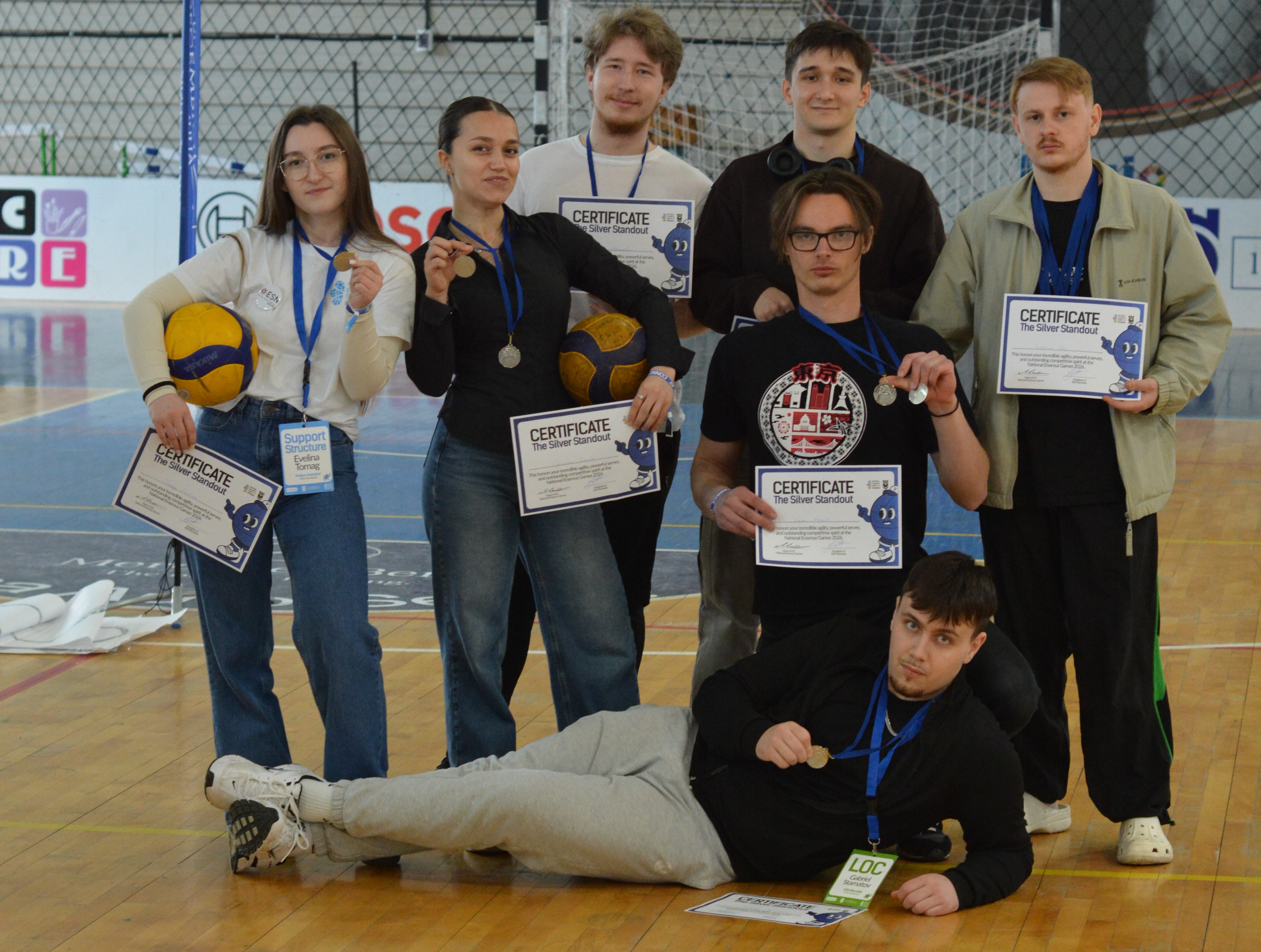 Standout team photo with medals and certificates